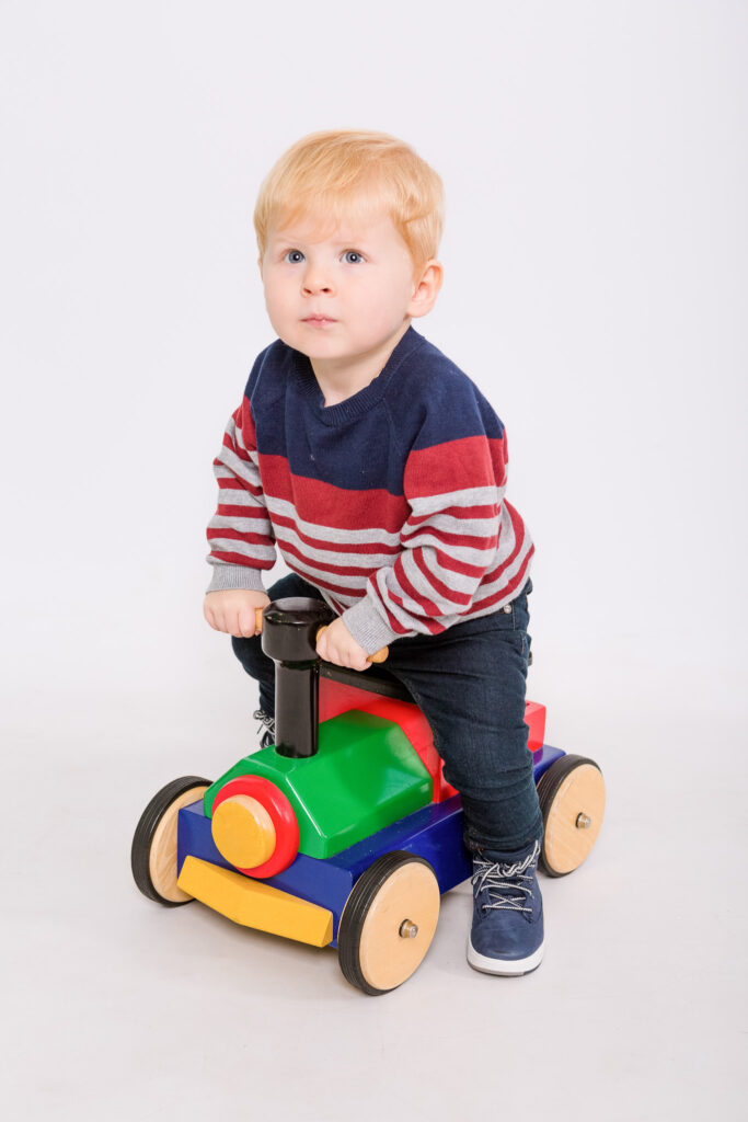 Child on little train toy - Playgroup session - kind words